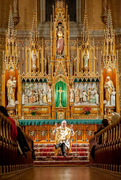 Priest speaks in church.