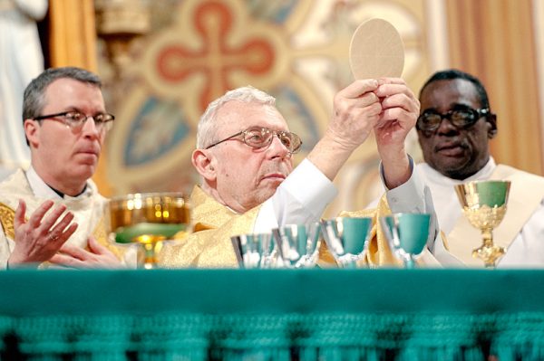 Priest performs Mass.